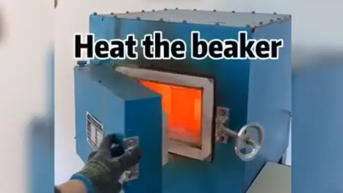 Laboratory oven heating a beaker with an orange glow, used for scientific research and chemical experiments.