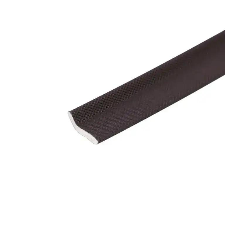 Close-up of black rubber edge trim with textured surface, used for sealing or finishing edges in construction or automotive applications.