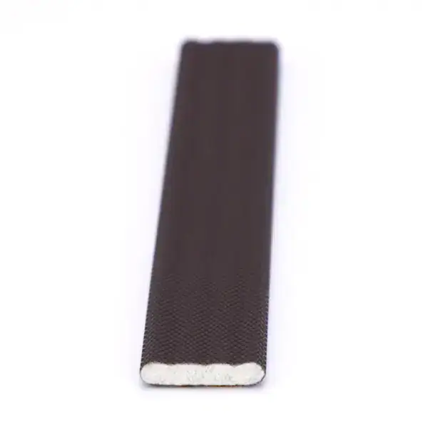 Close-up of a chalkboard eraser with a black felt surface and white foam backing, ideal for cleaning chalkboards in classrooms and art studios.