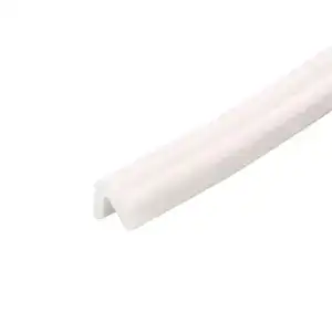 Close-up of a white plastic edge protector used for safety and protection of furniture or surfaces.