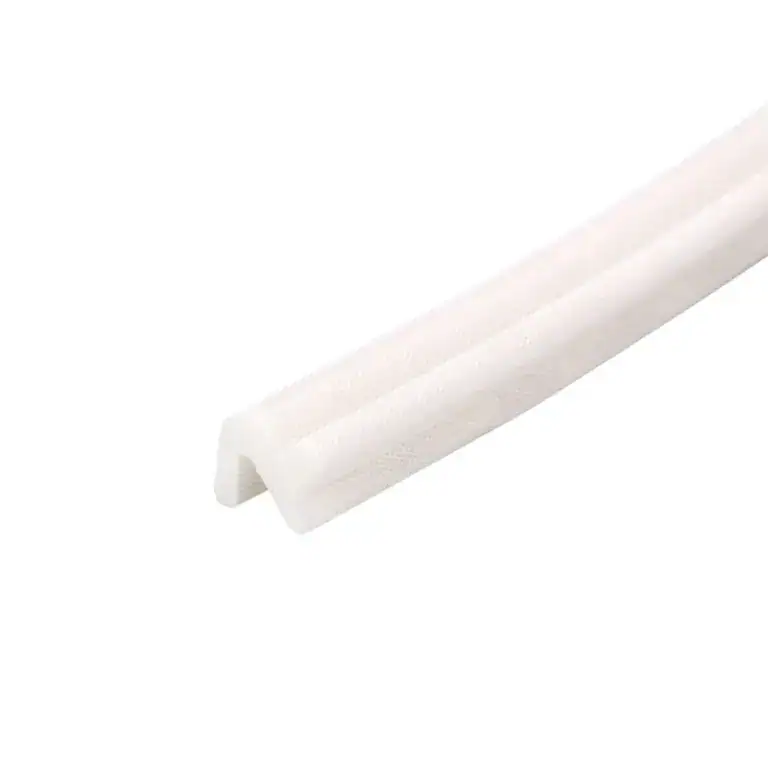 Close-up of a white plastic edge protector used for safety and protection of furniture or surfaces.
