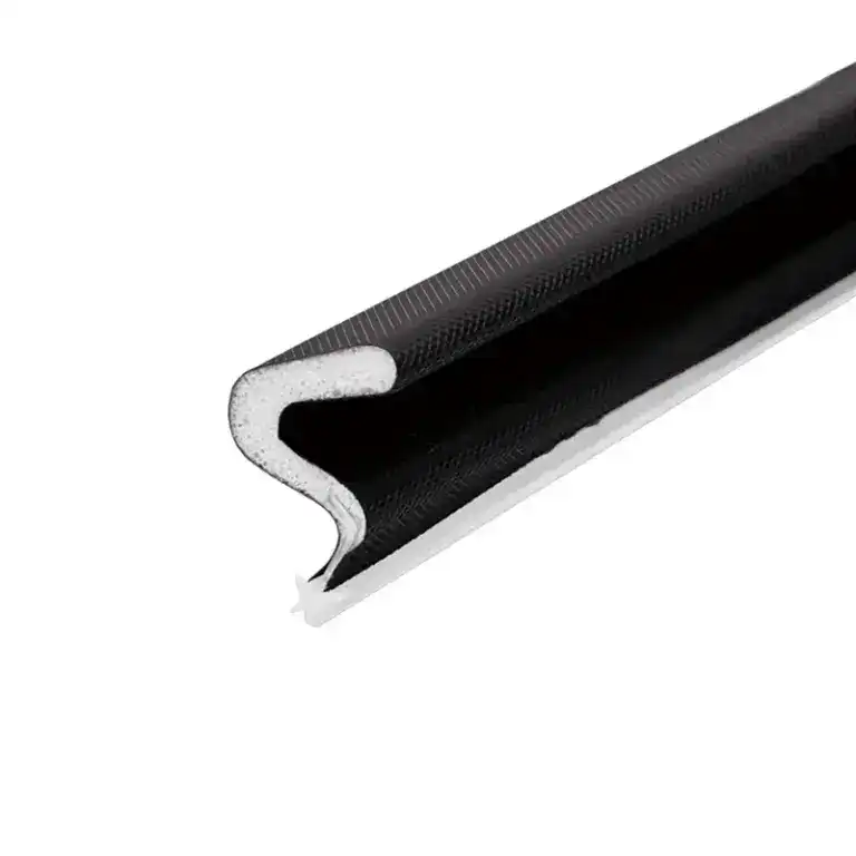 Close-up of a black flexible door seal with foam core for insulation and weatherproofing.