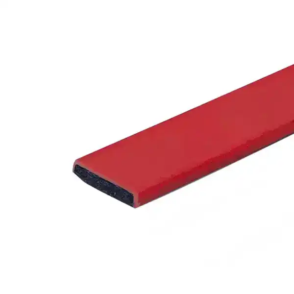 Close-up of a red rubber edge protector used for safety and cushioning on furniture or equipment edges.