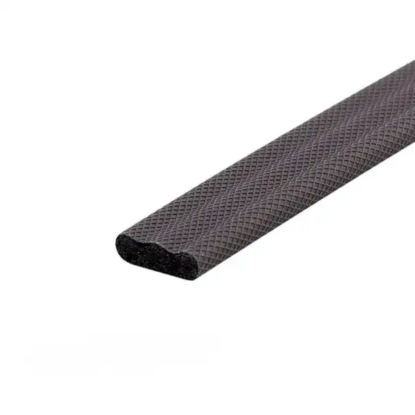 Close-up of black rubber edge strip with textured surface, used for safety and protection in industrial or construction settings.
