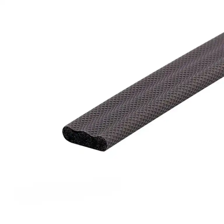 Close-up of black rubber edge strip with textured surface, used for safety and protection in industrial or construction settings.