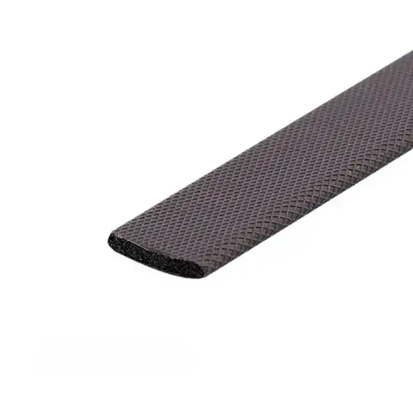 Close-up of a black rubber edge with textured surface, designed for safety and grip in industrial or construction applications.