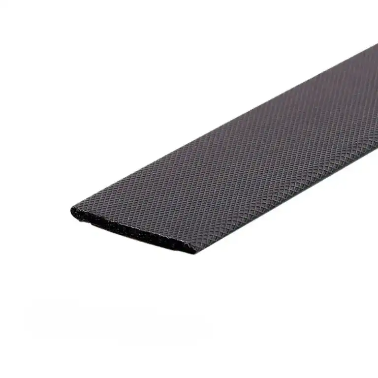 Close-up of a black rubber conveyor belt with textured surface for industrial use.