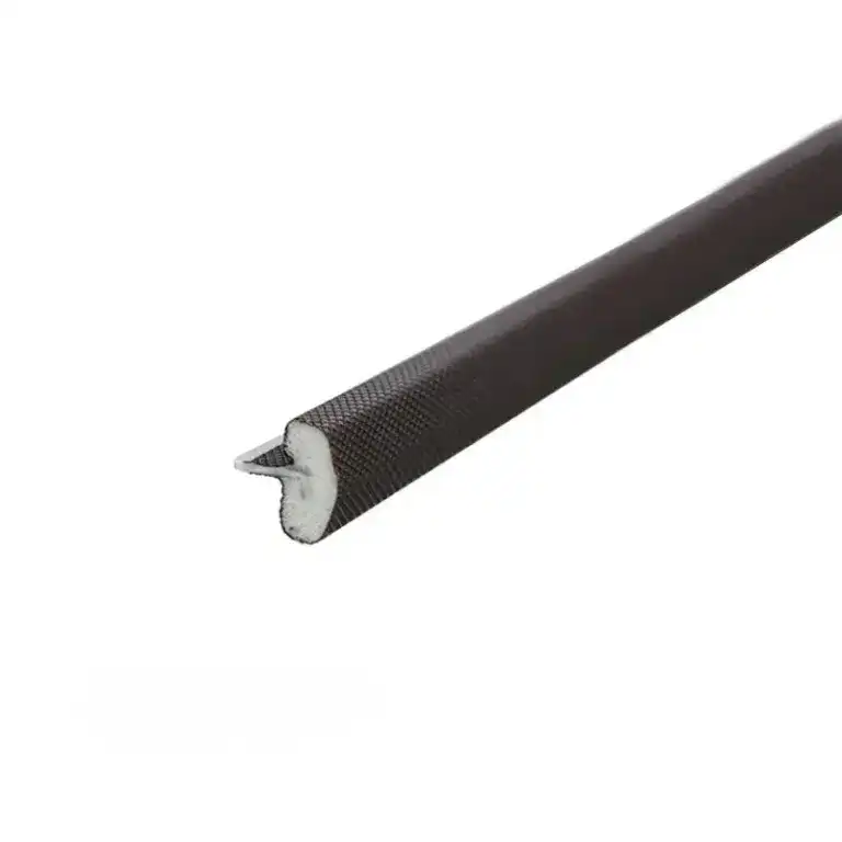 Close-up of a black flexible rubber seal with a metal core, used for sealing doors or windows to prevent drafts and improve insulation.