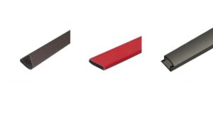 Close-up of fireproof sealing gaskets made from expanded graphite in black, red, and gray colors, used for smoke isolation and fire prevention in industrial settings.