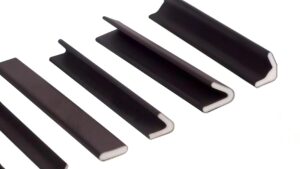 Close-up of black flexible sealing strips with white edges, used for sealing and insulation in construction and architectural applications.